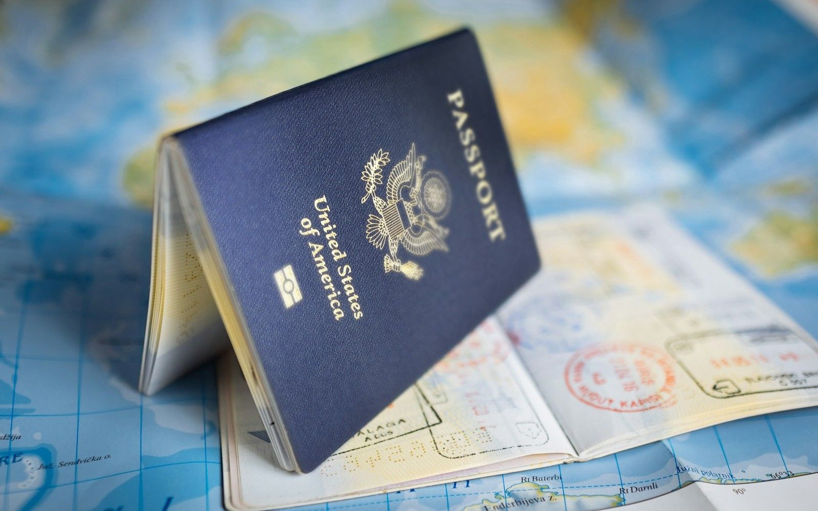 Passport and world map representing foreign assets in a Colombian divorce